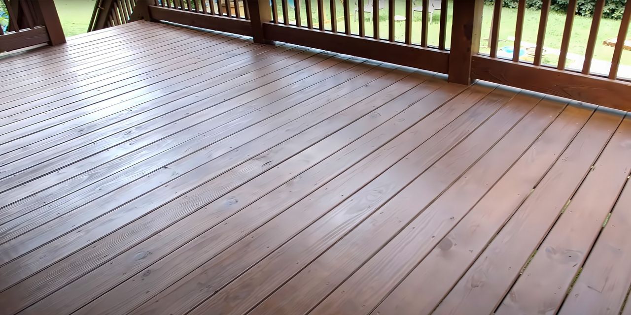 Freshly stained wooden deck on a covered porch