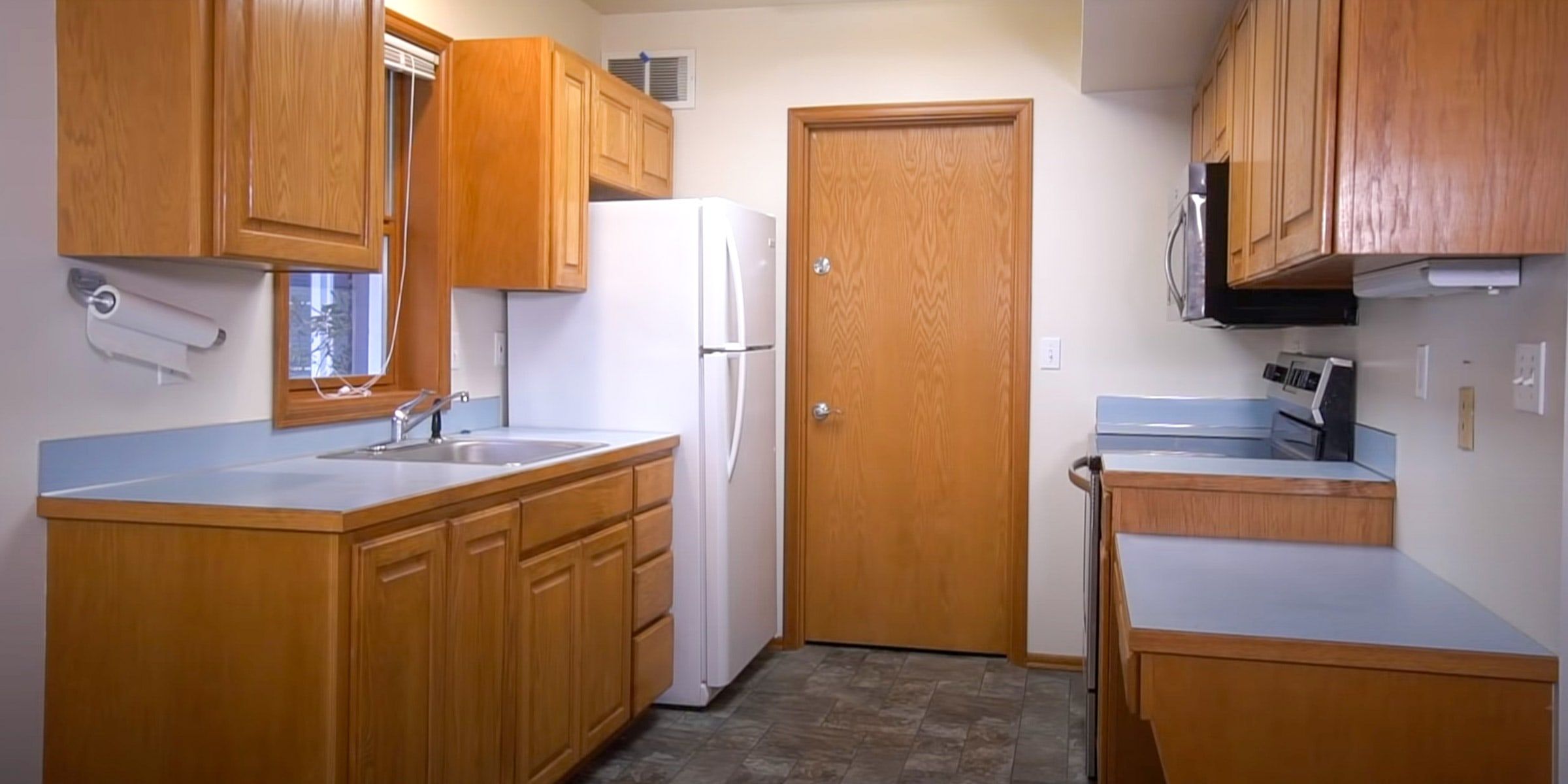 Kitchen with oak cabinets before painting
