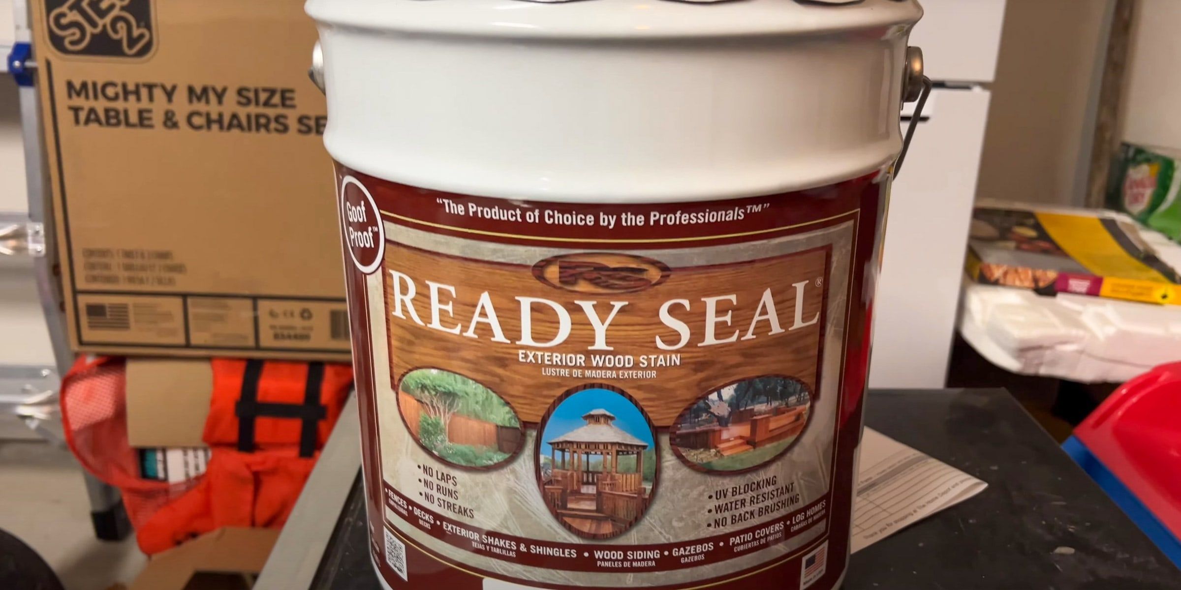 Bucket of wood stain at a job site