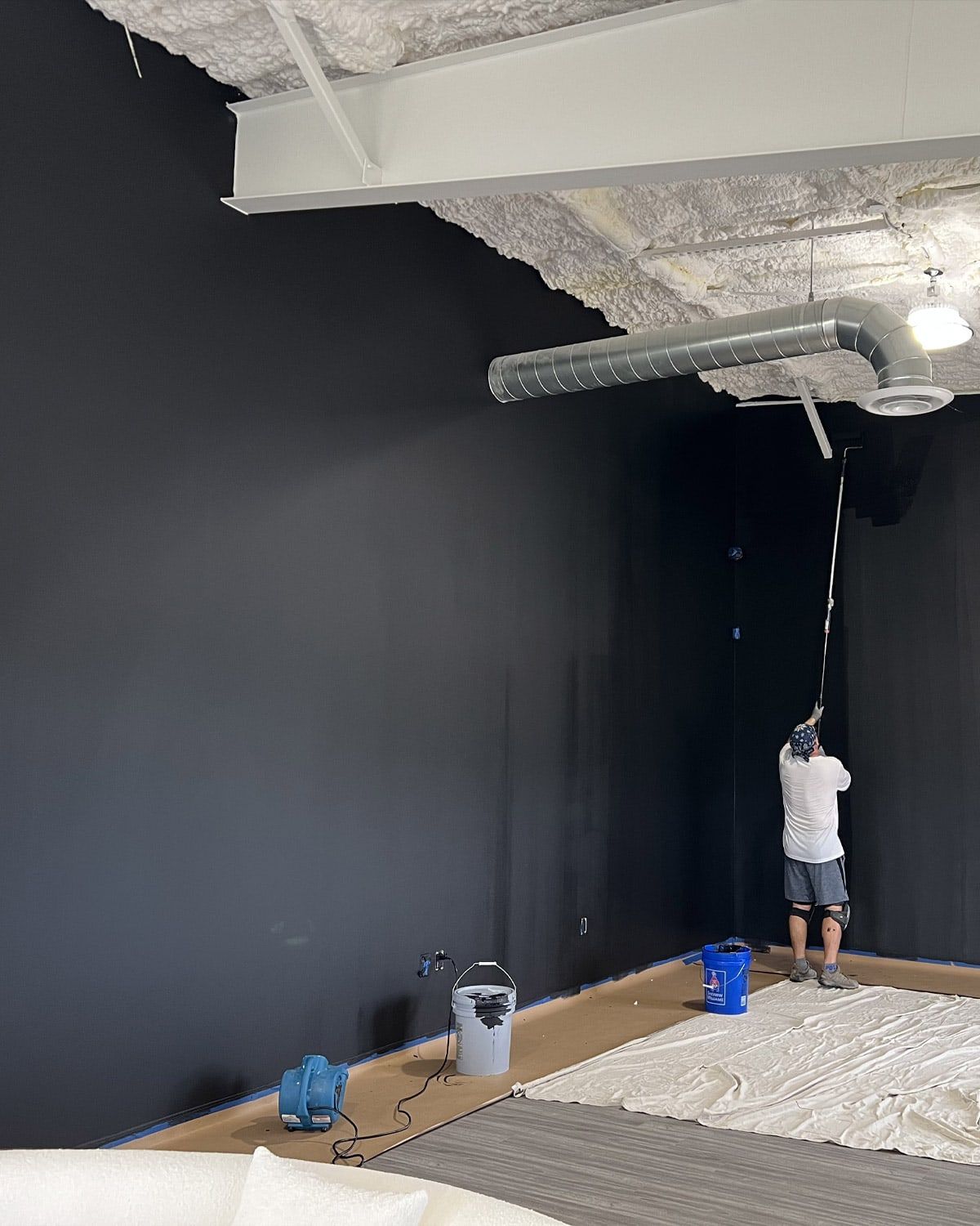 Painting a warehouse wall dark gray