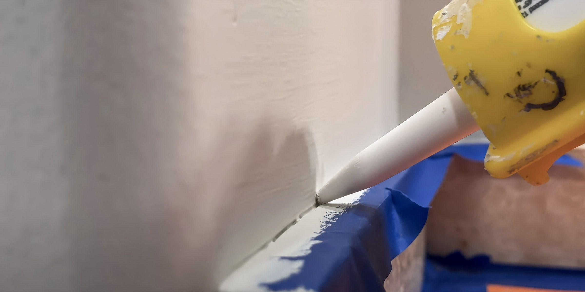 Caulking the gap between a wall and trim