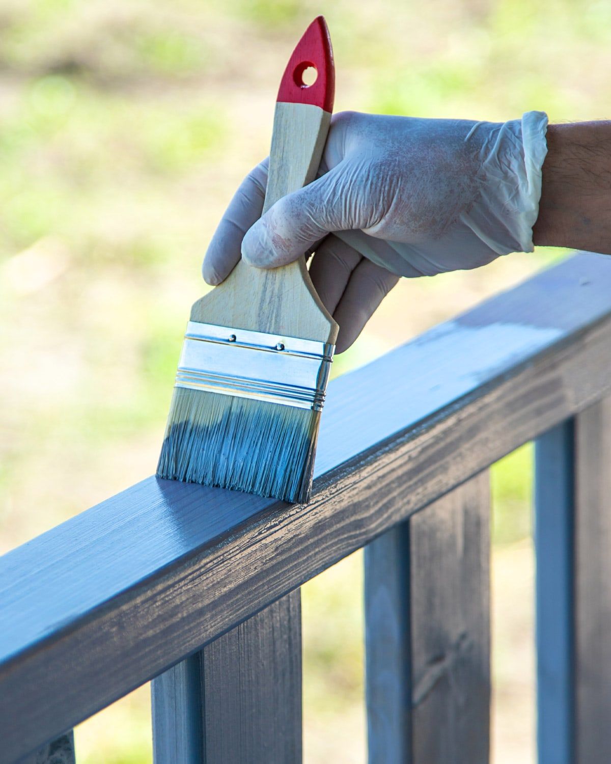 Painting deck railings with a brush
