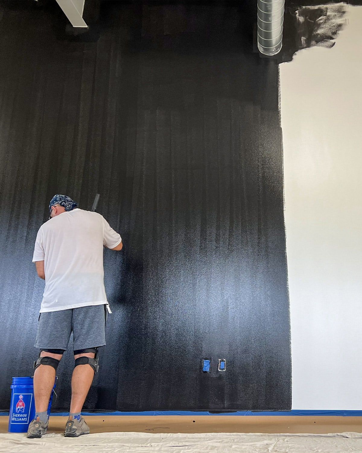 Rolling a warehouse wall with an extension pole