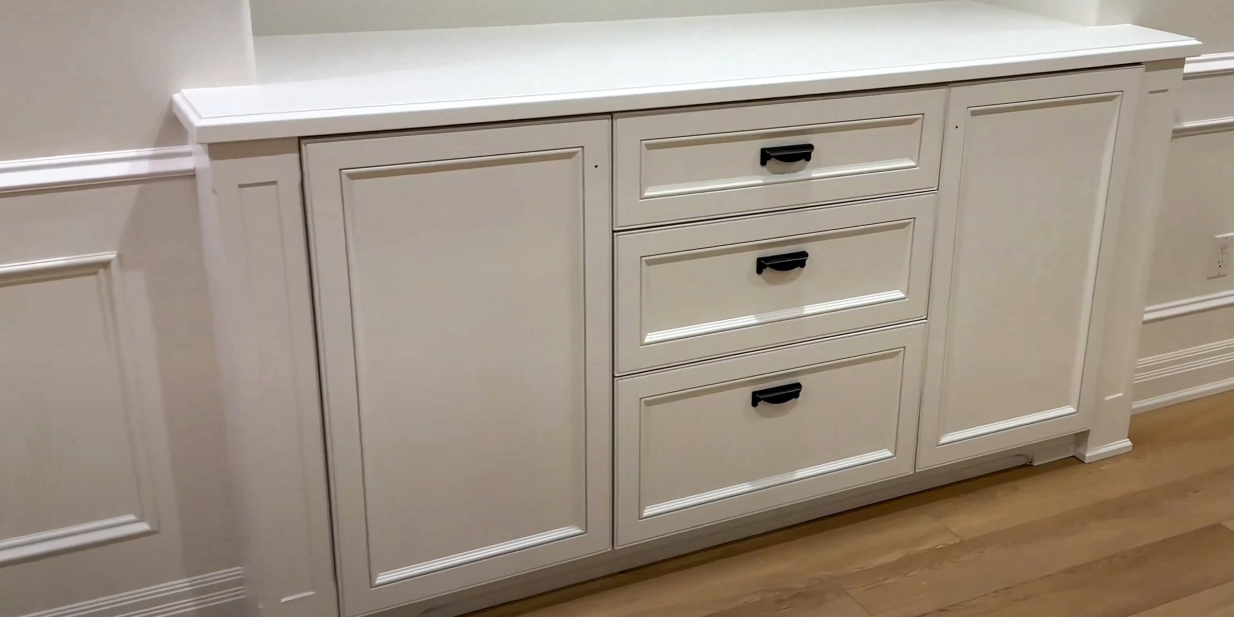 Painted white built-in cabinets with drawers