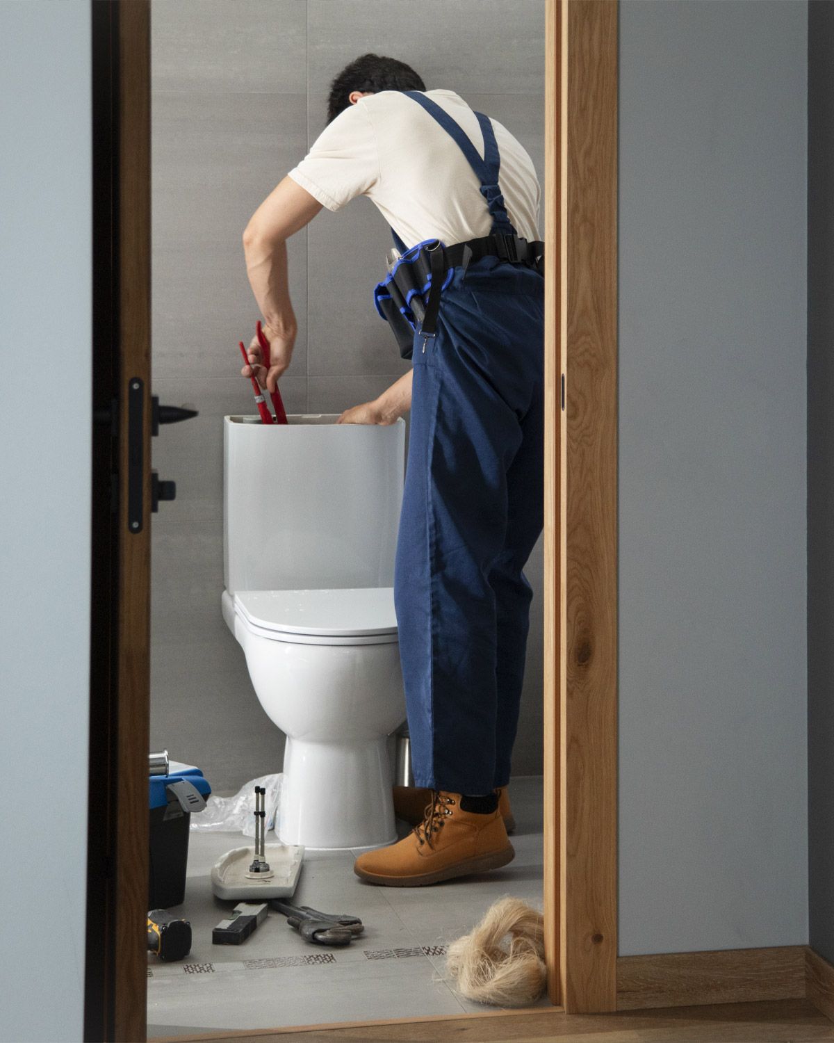 Repairing a toilet tank in a bathroom