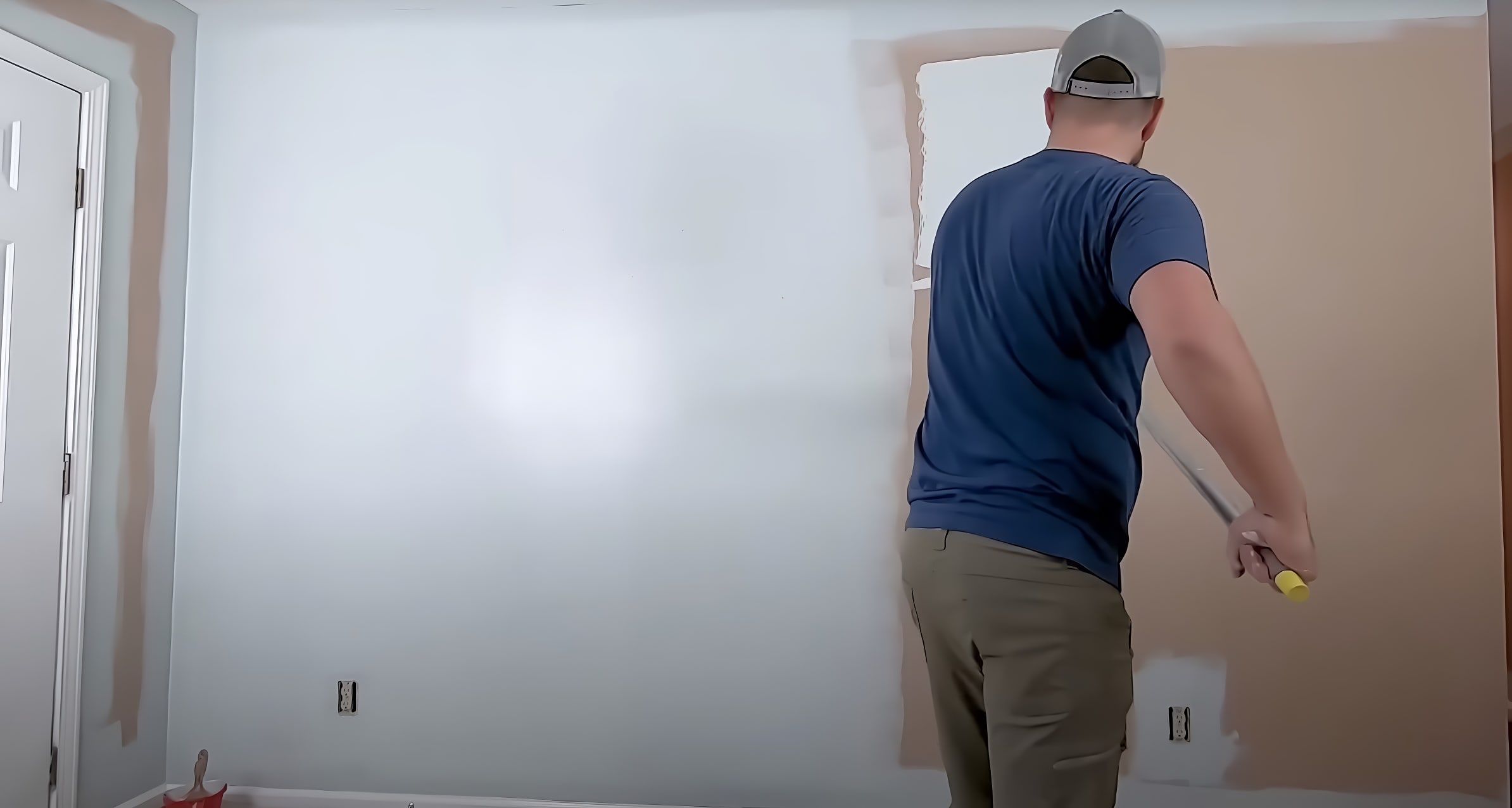Rolling paint over repaired spots on a wall